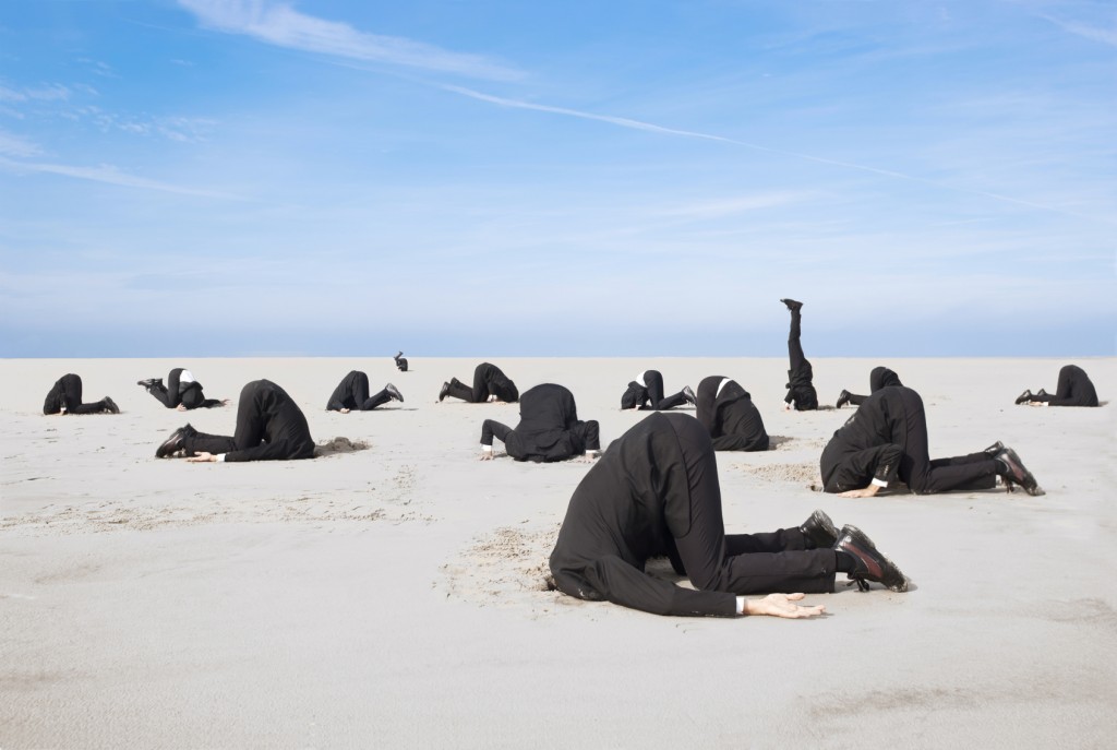 hiding head in sand _Medium